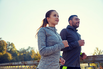 Image showing happy couple running outdoors