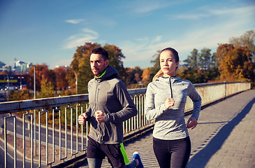 Image showing happy couple running outdoors