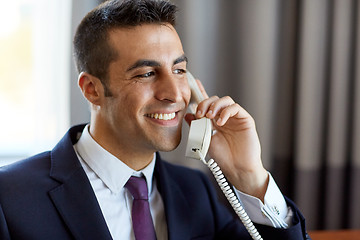 Image showing businessman calling on phone at hotel or office 