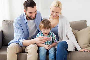 Image showing happy family with smartphone at home