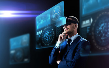 Image showing businessman in virtual reality headset and screens