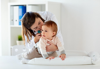 Image showing doctor with otoscope checking baby ear at clinic