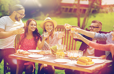 Image showing happy friends having dinner at summer garden party