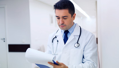 Image showing doctor writing to clipboard at hospital