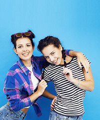 Image showing best friends teenage school girls together having fun, posing emotional on blue background, besties happy smiling, lifestyle people concept 