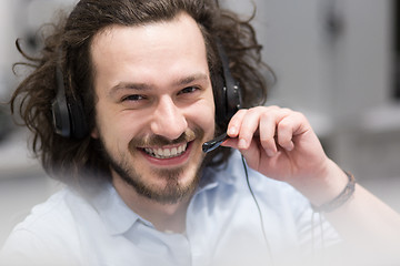 Image showing male call centre operator doing his job