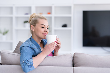 Image showing woman enjoying a cup of coffee