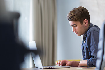 Image showing businessman working using a laptop in startup office