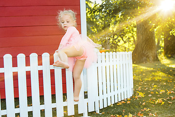 Image showing The little girl at playground against park or green forest