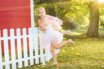 Image showing The two little girls at playground against park or green forest