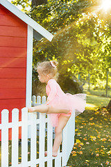 Image showing The little girl at playground against park or green forest