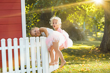 Image showing The two little girls at playground against park or green forest