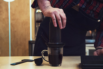 Image showing Barista brewing aeropress coffee