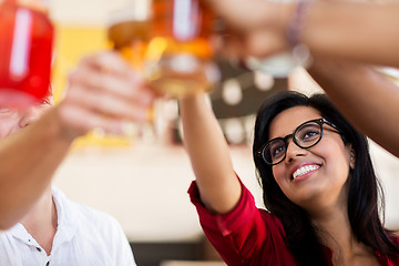 Image showing friends clinking glasses with drinks at restaurant