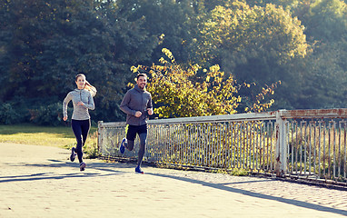 Image showing happy couple running outdoors