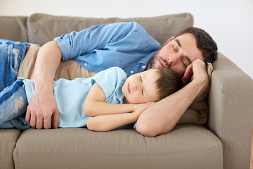 Image showing happy father and son sleeping on sofa at home