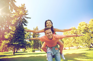 Image showing happy teenage couple having fun at summer park