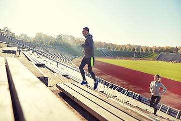 Image showing happy couple running upstairs on stadium