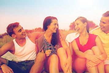 Image showing smiling friends in sunglasses on summer beach