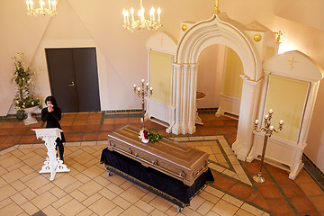 Image showing crying woman near coffin at funeral in church