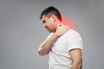 Image showing unhappy man suffering from neck pain