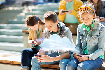 Image showing teenage friends with smartphones outdoors