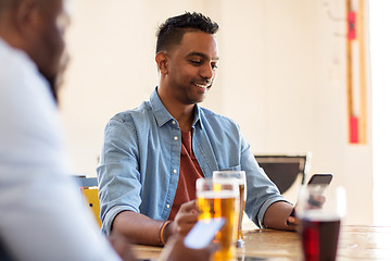 Image showing happy male friends drinking beer at bar or pub