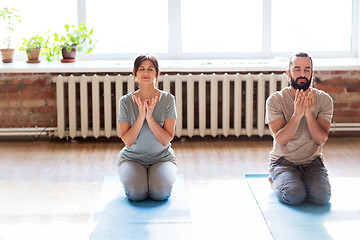 Image showing man and woman meditating at yoga studio