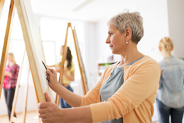 Image showing woman artist with pencil drawing at art school