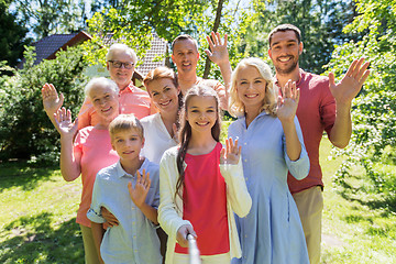 Image showing happy family taking selfie in summer garden