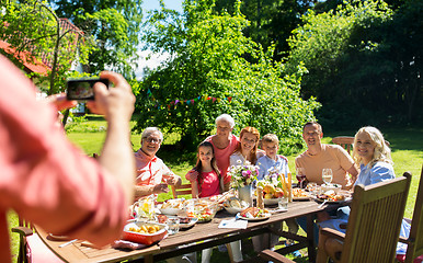 Image showing happy family photographing by smartphone in summer