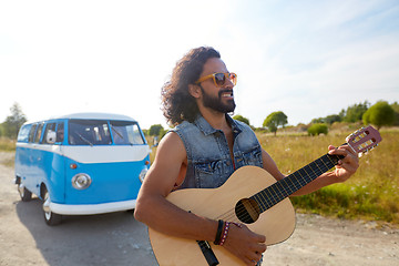 Image showing hippie man playing guitar at minivan car outdoor