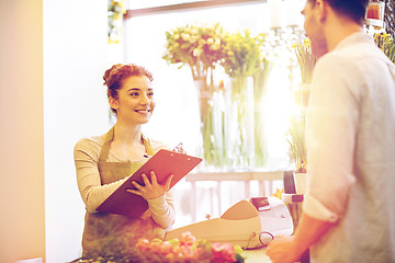 Image showing florist woman and man making order at flower shop