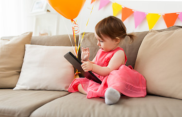 Image showing baby girl with tablet pc on birthday party at home