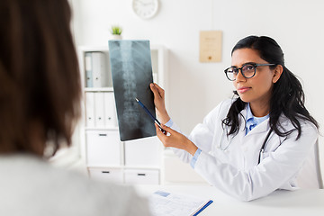 Image showing doctor with x-ray of spine and patient at hospital