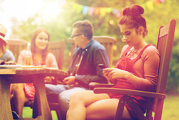 Image showing woman with smartphone and friends at summer party