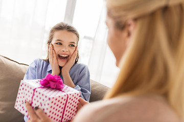 Image showing mother giving birthday present to girl at home