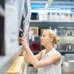 Image showing Woman shopping for furniture, sofa and home decor in store.