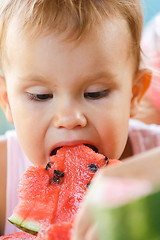 Image showing Child eating watermelon