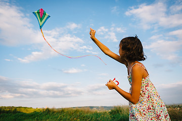 Image showing Girl playing with kite in field