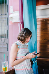 Image showing Girl using smartphone in cafe