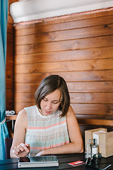 Image showing Girl in cafe with drink and tablet