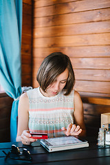 Image showing Girl in cafe with drink and tablet