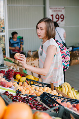 Image showing Girl making purchases in outside market