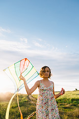 Image showing Girl holding kite and running in field