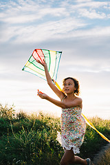 Image showing Girl holding kite and running in field