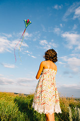 Image showing Girl playing with kite in field