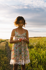 Image showing Girl holding kite and running in field