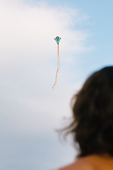 Image showing Girl watching kite flight