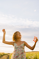 Image showing Girl holding kite and running in field